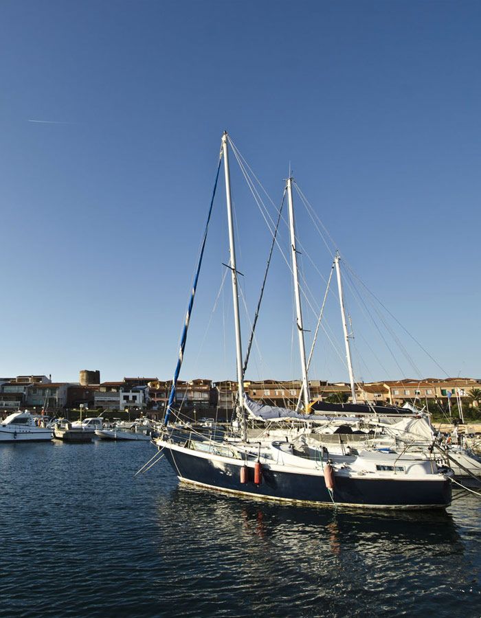 Sailing boat docked near our Sardinia accommodation agency